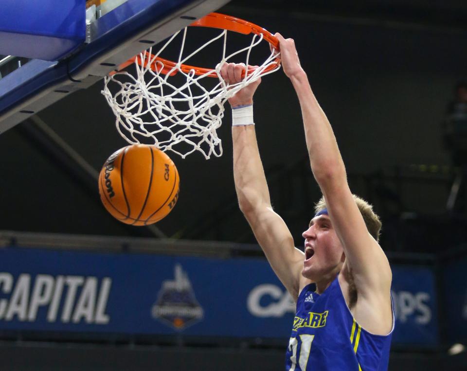 Delaware's Andrew Carr slams in the first half of the Colonial Athletic Association championship against UNCW at the Entertainment & Sports Arena in Washington, D.C., Tuesday, March 8, 2022.