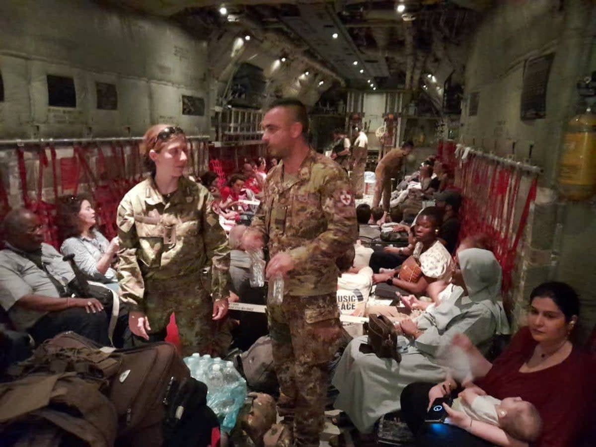 Italian citizens are boarded on an Italian Air Force C130 aircraft during their evacuation from Khartoum (via REUTERS)