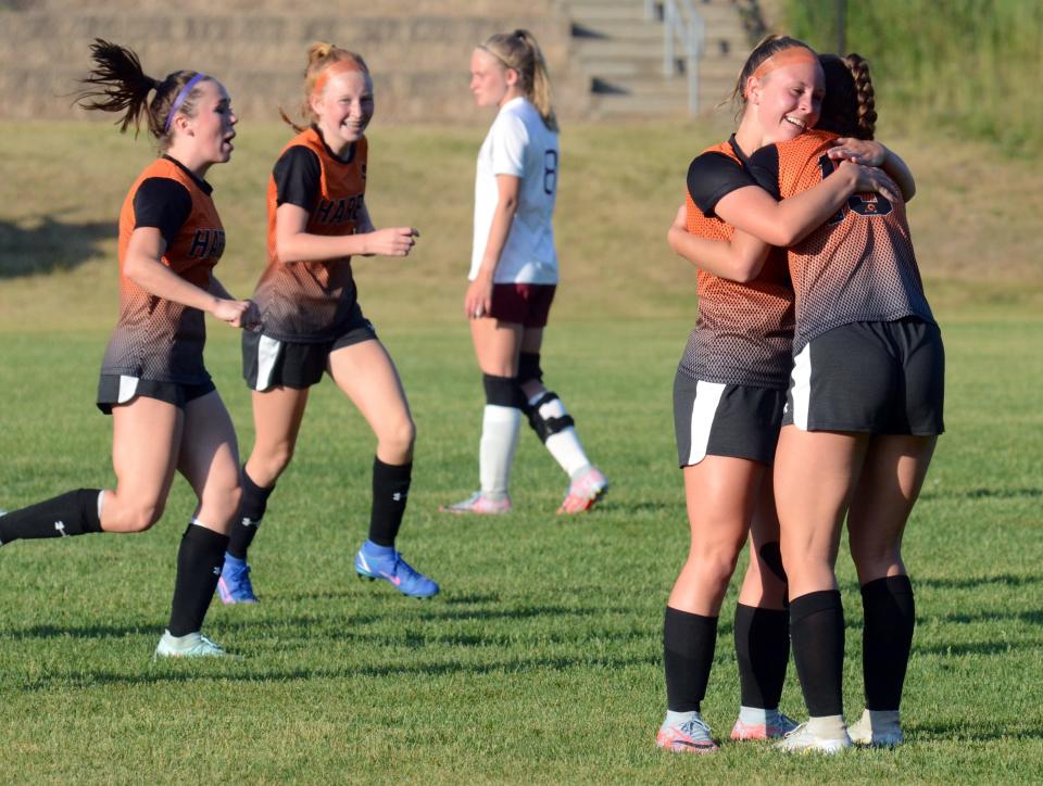 Harbor Springs' Teagan Inglehart hugs teammate Katelyn Drayer after her assist on a goal during the second half Tuesday.