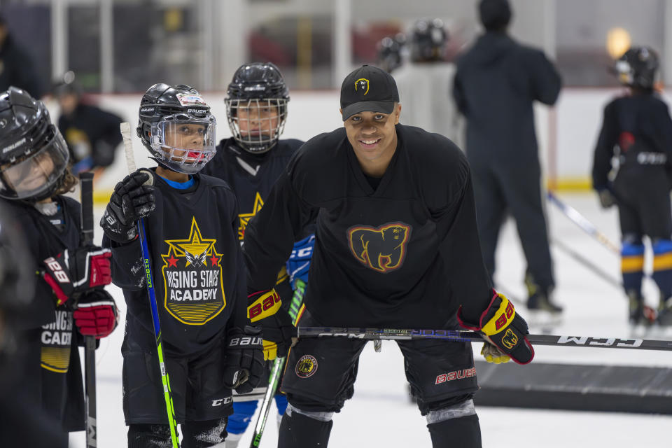 This photo provided by the Washington Capitals shows Maryland Black Bears junior player Kareem El-Bashir instructing players on the ice during the Washington Capitals' Rising Stars Academy, Saturday, Aug. 19, 2023, at MedStar Capitals Iceplex in Arlington, Virginia. The Rising Stars Academy included on-ice skills training and off-ice seminars aimed at helping kids navigate some of the challenges hockey presents. (Jess Rapfogel/Washington Capitals via AP)