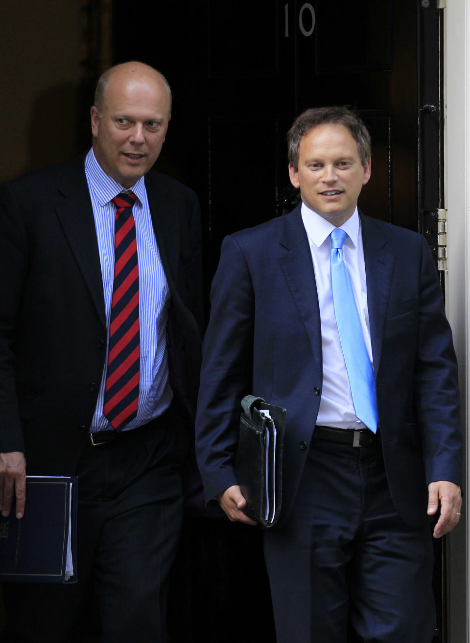 New Justice Secretary Chris Grayling, left, and new party chairman Grant Shapps, leave 10 Downing Street in London after a Cabinet meeting, Wednesday, Sept. 5, 2012. (AP Photo/Sang Tan)