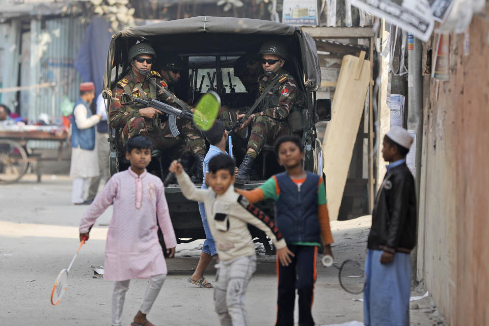 Bangladesh Army soldiers keep guard outside a polling booth in Dholaipar area in Dhaka, Bangladesh, Friday, Jan. 5, 2024. Bangladesh’s main opposition party called for general strikes on the weekend of the country's parliamentary election, urging voters to join its boycott. This year, ballot stations are opening amid an increasingly polarized political culture led by two powerful women; current Prime Minister Sheikh Hasina and opposition leader and former premier Khaleda Zia. (AP Photo/Mahmud Hossain Opu)