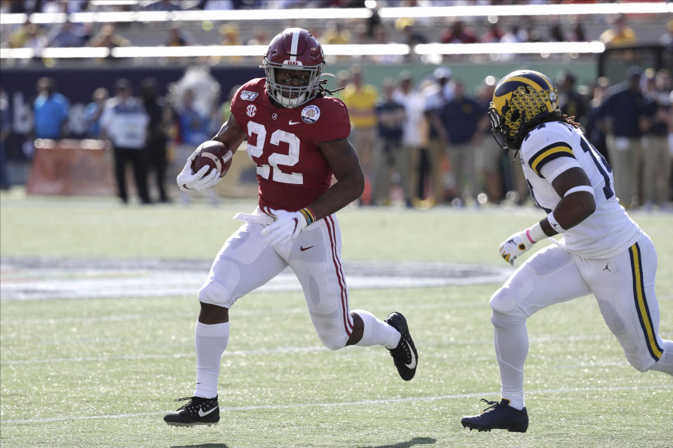 Alabama running back Najee Harris (22) runs against Michigan during the first half of the Citrus Bowl NCAA college football game, Wednesday, Jan. 1, 2020, in Orlando, Fla. (AP Photo/John Raoux)