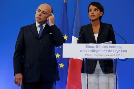 French Interior Minister Bernard Cazeneuve (L) and Education Minister Najat Vallaud-Belkacem attend a news conference to announce security plans for schools, in Paris, France, August 24, 2016. REUTERS/Pascal Rossignol