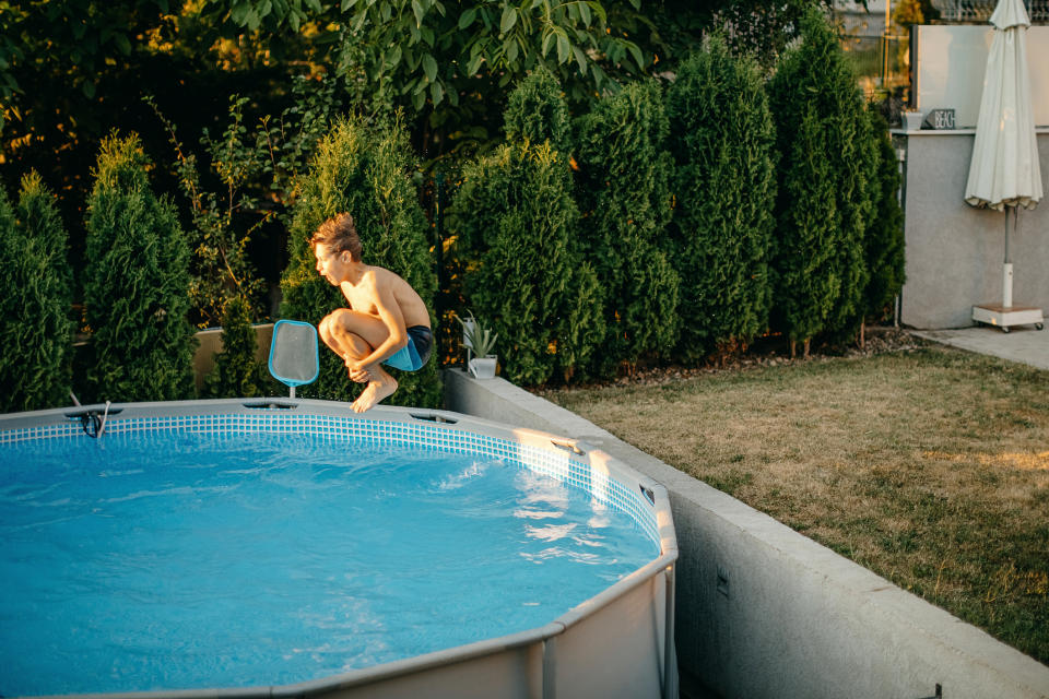 A child jumping into a pool