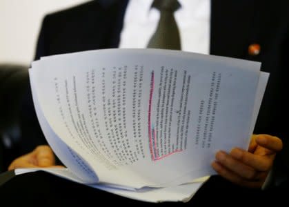 North Korea's ambassador to the United Nations Han Tae Song reads documents during an interview with Reuters at the Permanent Mission of North Korea in Geneva, Switzerland, November 17, 2017. REUTERS/Denis Balibouse