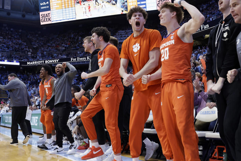 The Clemson bench celebrates a teammate's score against North Carolina during the second half of an NCAA college basketball game Tuesday, Feb. 6, 2024, in Chapel Hill, N.C. (AP Photo/Chris Seward)