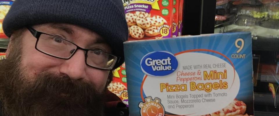Man poses with Great Value Mini pizza bagels.
