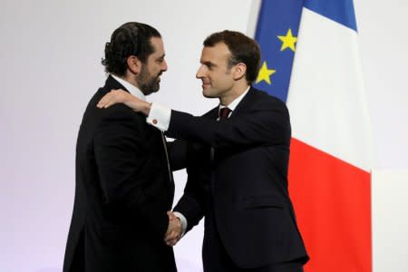 FILE PHOTO: French President Emmanuel Macron (R) shakes hands with Lebanese Prime Minister Saad Hariri during the Cedar (CEDRE) Conference for international donors and investors to support Lebanon's economy, in Paris, France, April 6, 2018.   Ludovic Marin/Pool via Reuters/File Photo