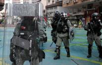 Riot police officers block the street during an anti-government protest in Hong Kong