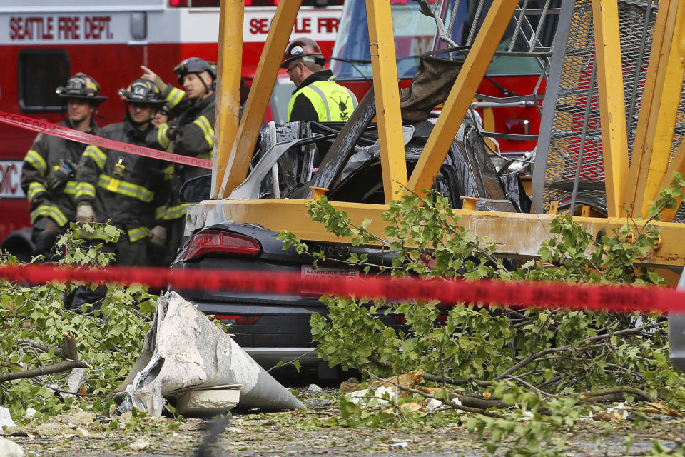 A construction crane working on a building collapsed near the intersection of Mercer Street and Fairview Avenue near Interstate 5, Saturday, April 27, 2019, in downtown Seattle. Authorities say several people have died and a few others are hospitalized after the construction crane fell onto a street pinning cars underneath Saturday afternoon. (Genna Martin/seattlepi.com via AP)