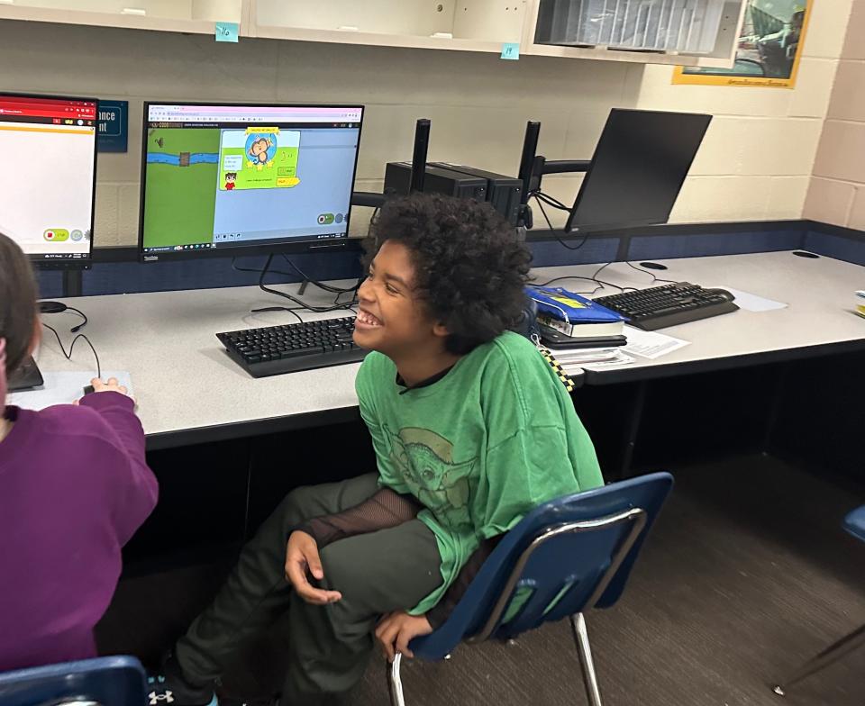 Sebring McKinley seventh-grader Quincy Taylor enjoys playing coding games with his classmates as part of the “Hour of Code” event during early December.