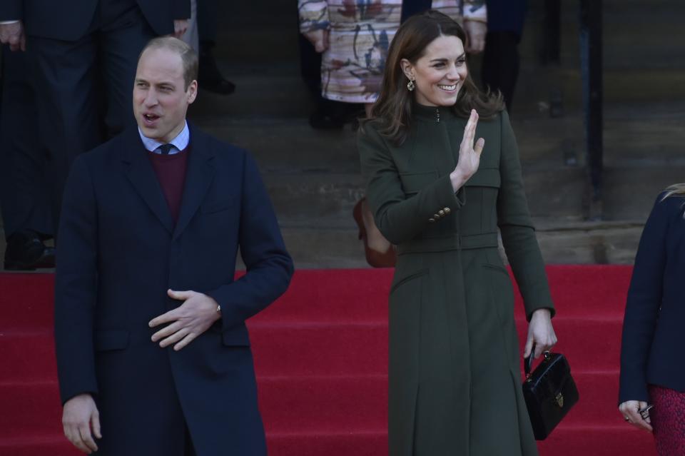 Britain's Prince William, left, smiles as Kate Duchess of Cambridge waves to the crowd after their meeting with the members of the public at Centenary Square in Bradford northern England, Wednesday, Jan. 15, 2020. (AP Photo/Rui Vieira)