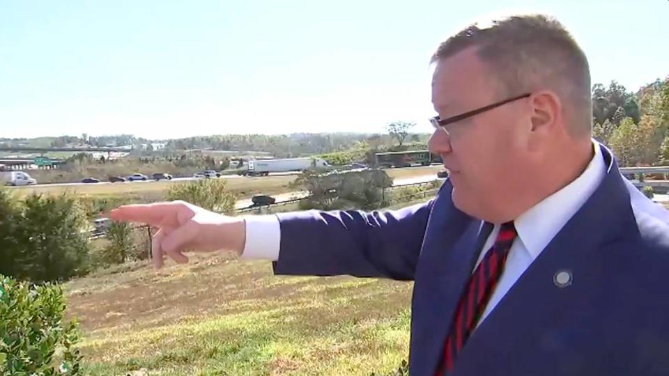 House Speaker Tim Moore points to heavy traffic at the I-85-I-485 intersection in western Mecklenburg County at a press event announcing $45 million funding to add new lanes to reduce a bottleneck.