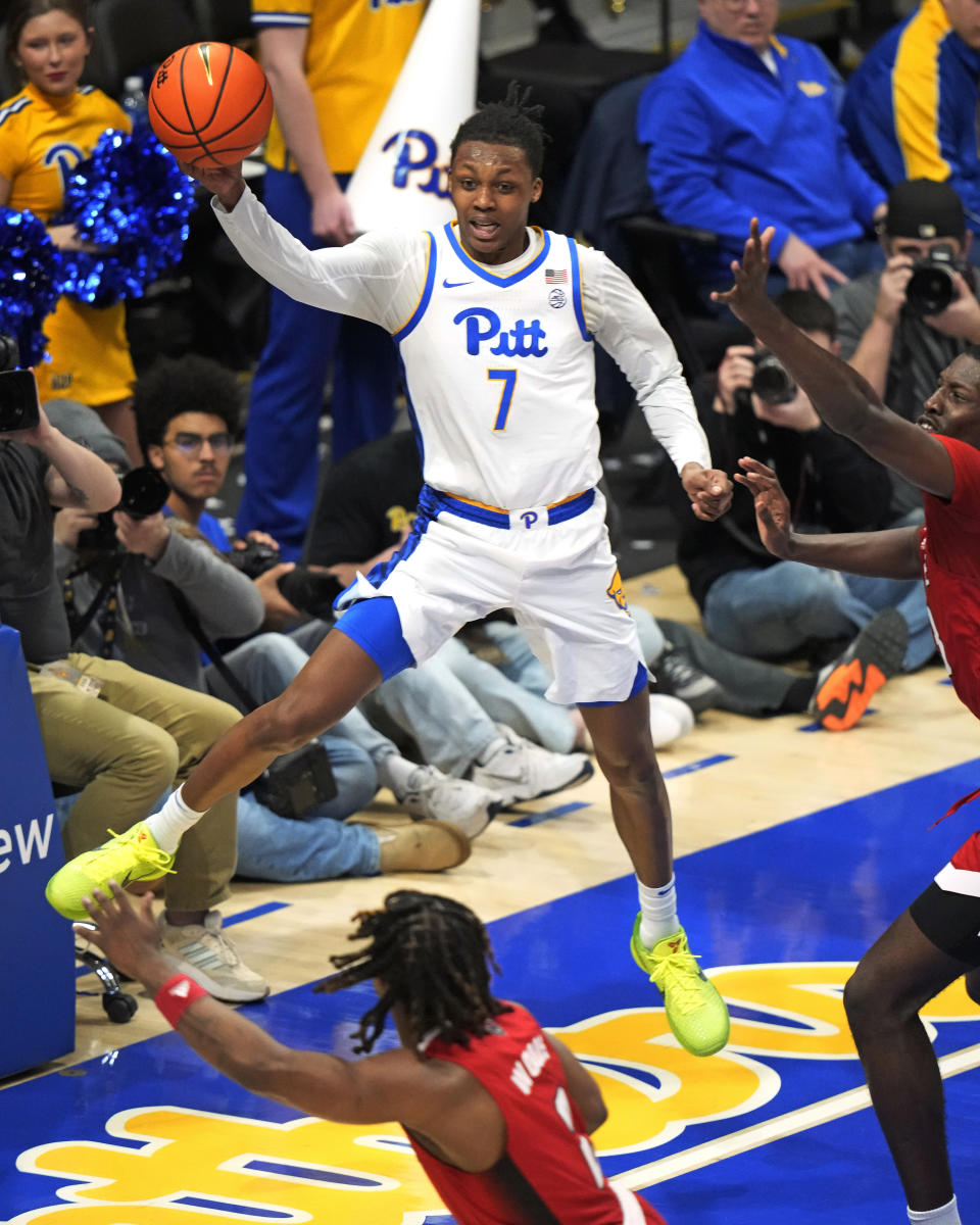 Pittsburgh's Carlton Carrington (7) gets off a pass with North Carolina State's Mohamed Diarra, right, defending during the second half of an NCAA college basketball game in Pittsburgh Saturday, March 9, 2024. (AP Photo/Gene J. Puskar)