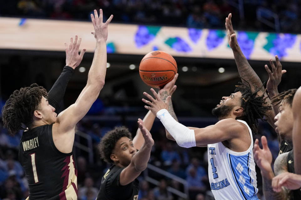 Florida State guard Jalen Warley, left, and forward Baba Miller, center, combine to guard North Carolina guard RJ Davis during the first half of an NCAA college basketball game in the quarterfinal round of the Atlantic Coast Conference tournament Thursday, March 14, 2024, in Washington. (AP Photo/Susan Walsh)