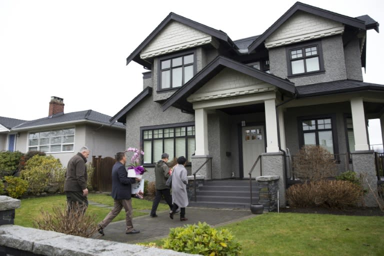 Individuals with flowers exiting from a vehicle with consular plates arrive at the residence of Huawei Technologies Chief Financial Officer Meng Wanzhou after she was released on bail in Vancouver, British Columbia