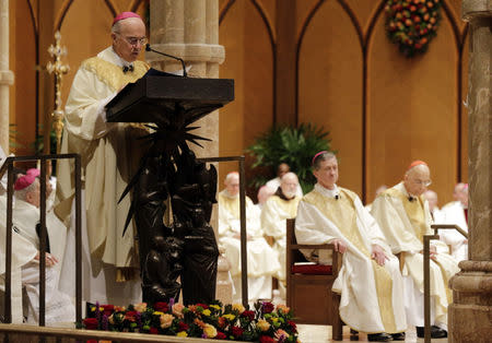FILE PHOTO: Archbishop Carlo Maria Vigano, Apostolic Nuncio of the United States, reads the Apostolic Mandate during the Installation Mass of Archbishop Blase Cupich at Holy Name Cathedral in Chicago November 18, 2014. REUTERS/Charles Rex Arbogast/Pool