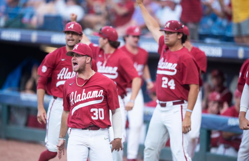 Alabama pitcher Jake Leger (30), infielder Eric Foggo (24), and teammates react to a run scored as Alabama Crimson Tide takes on Texas A&M Aggies during the SEC baseball tournament at the Hoover Metropolitan Stadium in Hoover, Ala., on Friday, May 27, 2022.