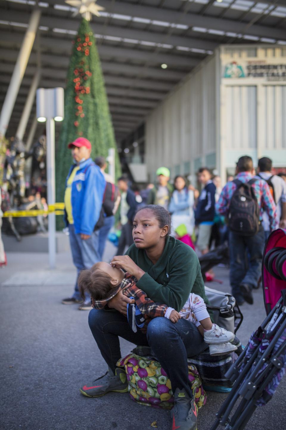 Central American migrants gather outside a subway station after leaving a temporary shelter in the Jesus Martinez stadium, in Mexico City, Friday, Nov. 9, 2018. A group of 500 migrants decided to get ahead of the caravan and head north towards the city of Queretaro. (AP Photo/Rodrigo Abd)