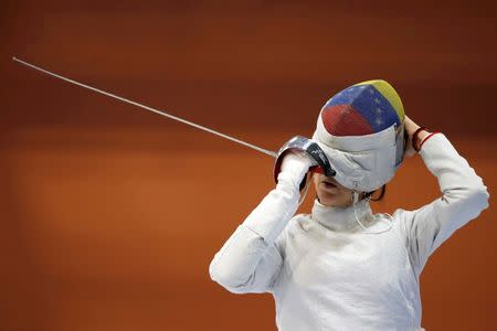 2016 Rio Olympics - Fencing - Women's Training - Riocentro - Rio De Janeiro, Brazil - 31/07/2016. Venezuela's Alejandra Benitez adjusts her mask in practices. REUTERS/Edgard Garrido