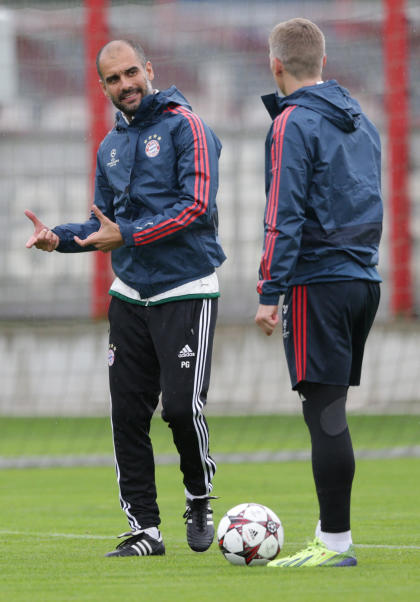 Pep Guardiola talks to Bastian Schweinsteiger during a training session in Munich. (AP Photo)