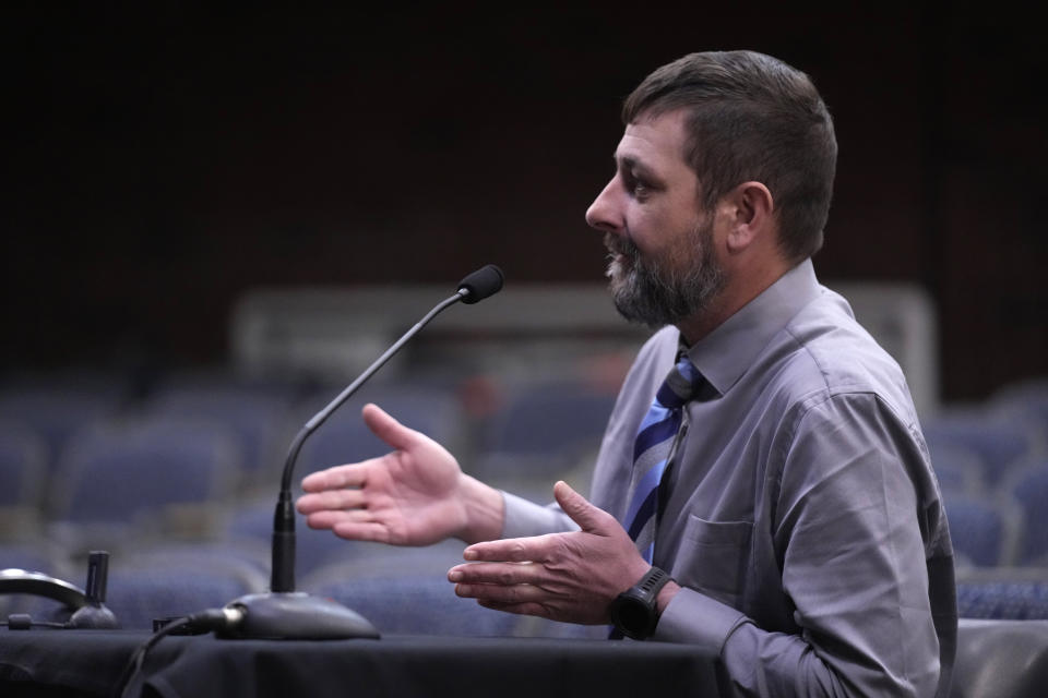 Sean Hodgson, a member of the U.S. Army Reserve, gives testimony, Thursday, April 25, 2024, in Augusta, Maine, during a hearing of the independent commission investigating the law enforcement response to the mass shooting in Lewiston, Maine. (AP Photo/Robert F. Bukaty)