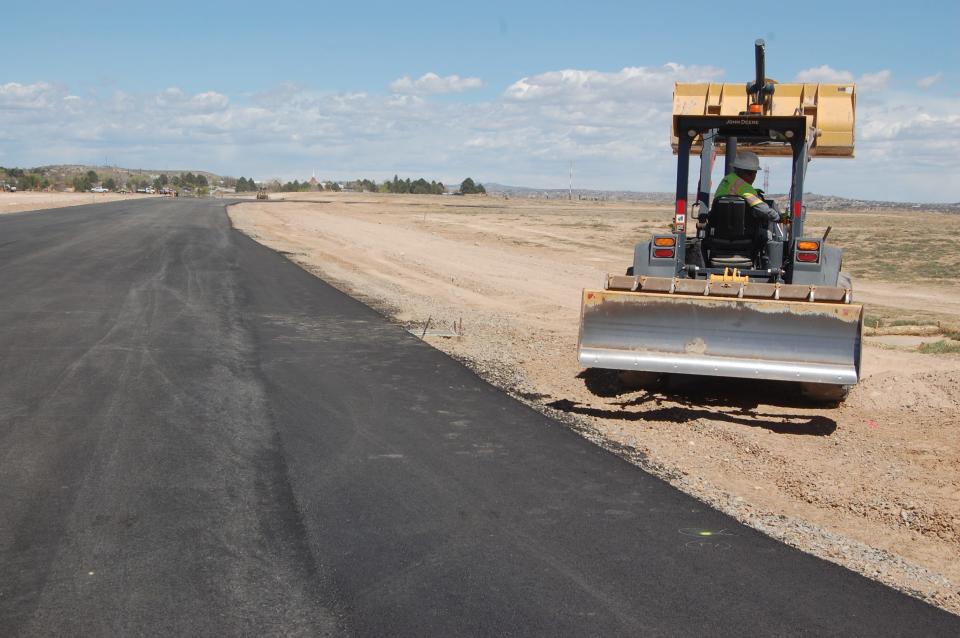 A workers from Four Corners Materials moves dirt next to one of the new taxiways at the Four Corners Regional Airport in April 2023.