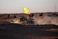 Members of Iraq's Popular Mobilisation units hold a position on the outskirts of the Iraqi town of Ad-Dawr, on March 6, 2015, during a military operation to retake the Tikrit area from the Islamic State group