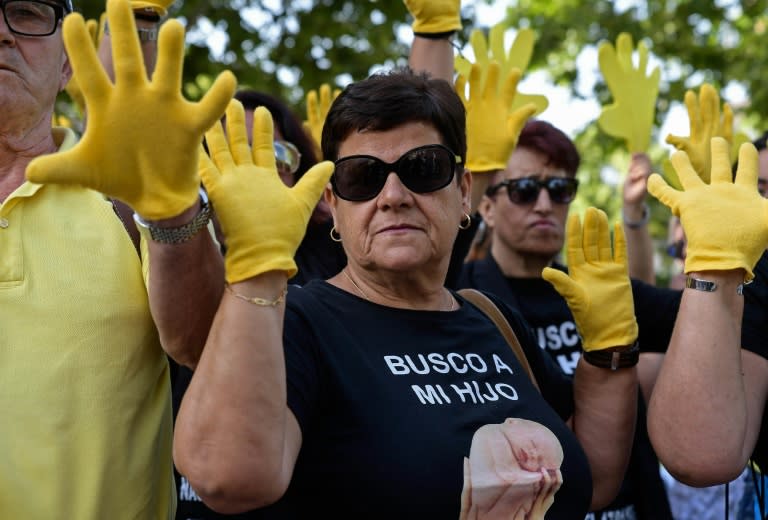 At a previous hearing in June, a woman wore a T-shirt reading "I look for my son" outside the court