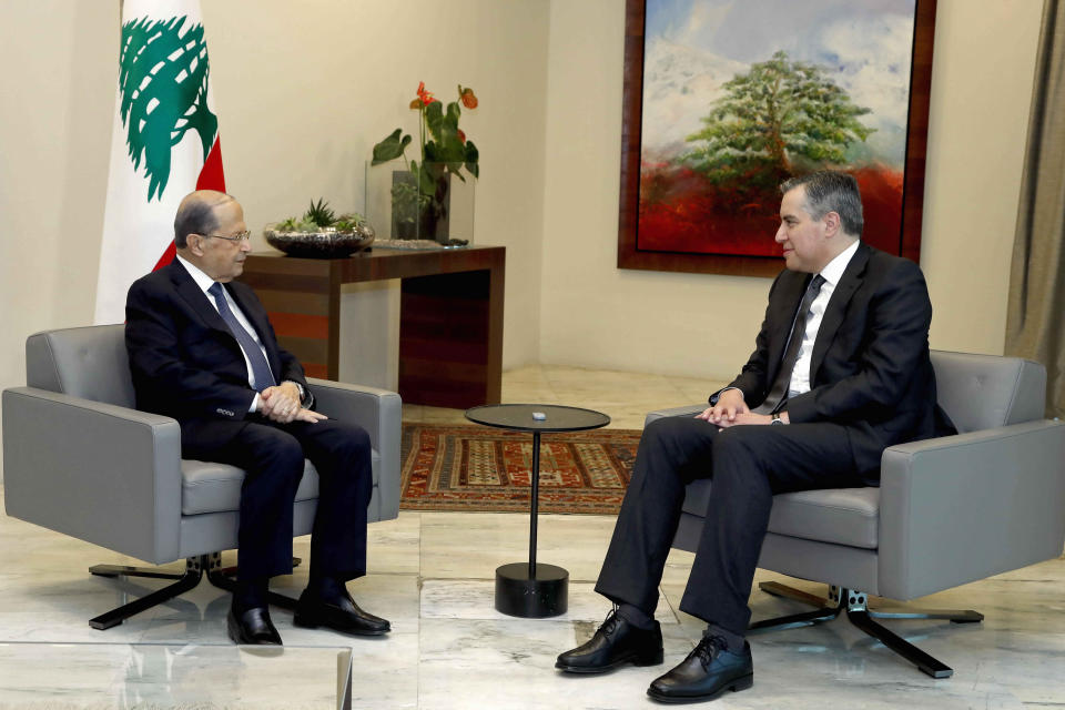 In this photo released by Lebanon's official government photographer Dalati Nohra, Lebanese President Michel Aoun, left, meets with Prime Minister-Designate Mustapha Adib, at the presidential palace, in Baabda, east of Beirut, Lebanon, Monday, Sept. 14, 2020. Lebanese officials are holding eleventh-hour negotiations over the formation of a new government, a process which hit snags over the weekend despite a looming deadline to deliver on a promise made to French President Emmanuel Macron. (Dalati Nohra via AP)