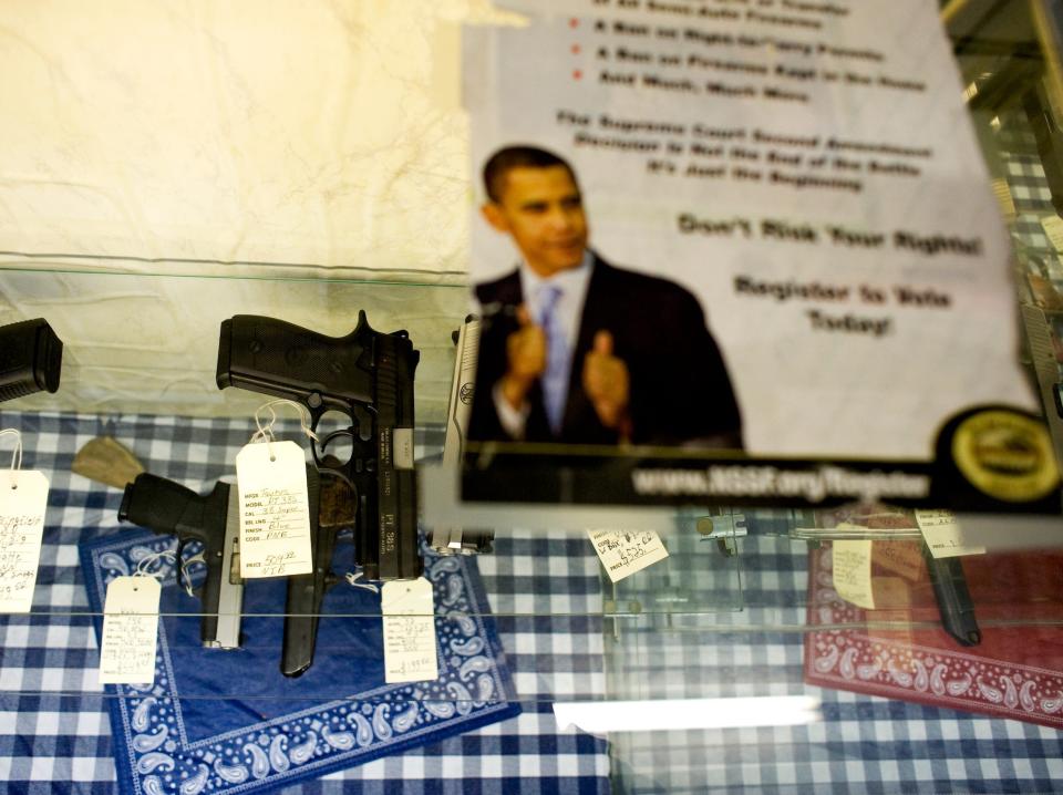 A sign explaining a version of Obama's gun control policies sits taped at a gun store in 2008.
