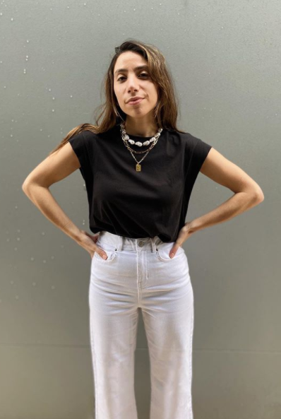 A shopper wearing a $9 Kmart t-shirt in black with white jeans