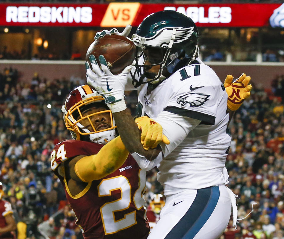 Philadelphia Eagles wide receiver Alshon Jeffery (17) pulls in a touchdown pass under pressure from Washington Redskins cornerback Josh Norman (24) during the first half of the NFL football game between the Washington Redskins and the Philadelphia Eagles, Sunday, Dec. 30, 2018 in Landover, Md. (AP Photo/Alex Brandon)