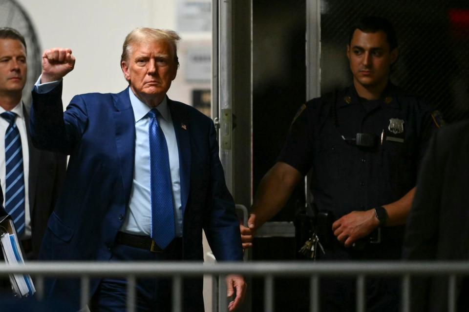 Former President Donald Trump gestures as he walks to the courtroom following a break in his trial at Manhattan criminal court Thursday, May 9, 2024, in New York (AP)