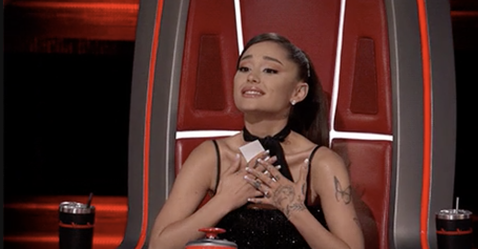 ariana grande with her hands over her heart dramatically
