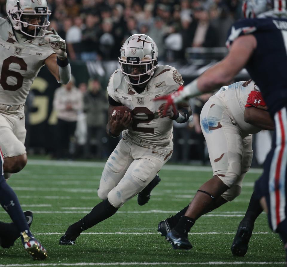 Quarterback Tyhier Tyler of Army makes a cut against Navy. CHRIS PEDOTA/USA TODAY Sports