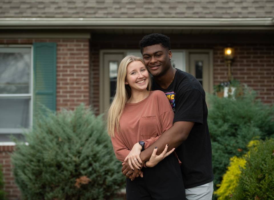 Jadrien and McKenna Higginson pose for a portrait in front of their home in Newburgh, Ind., Friday afternoon, Nov. 4, 2022. 