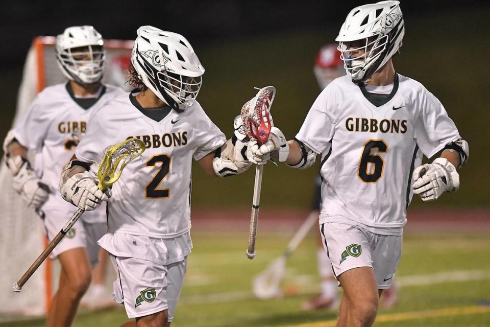 Cardinal Gibbons’ Charlie Carmouche (6) celebrates with Carter Malone (2) after Malone’s goal in the second half. The Charlotte Catholic Cougars and the Cardinal Gibbons Crusaders met in the NCHSAA 4A Girls Lacrosse Final in Durham , NC on May 19, 2023.