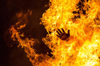 <p>A reveler jumps over a bonfire during the Night of San Juan in Alcobendas, near Madrid, June 24, 2015. (AP Photo/Andres Kudacki) </p>