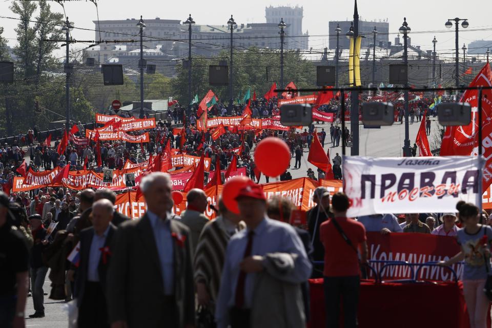 Thousands of Communists march during a May Day demonstration in downtown Moscow, Russia, Thursday, May, 1, 2014. Meanwhile about 100,000 people marched through Red Square to celebrate May Day, the first time the annual parade has been held on the vast cobblestoned square outside the Kremlin since the fall of the Soviet Union in 1991. (AP Photo/Denis Tyrin)