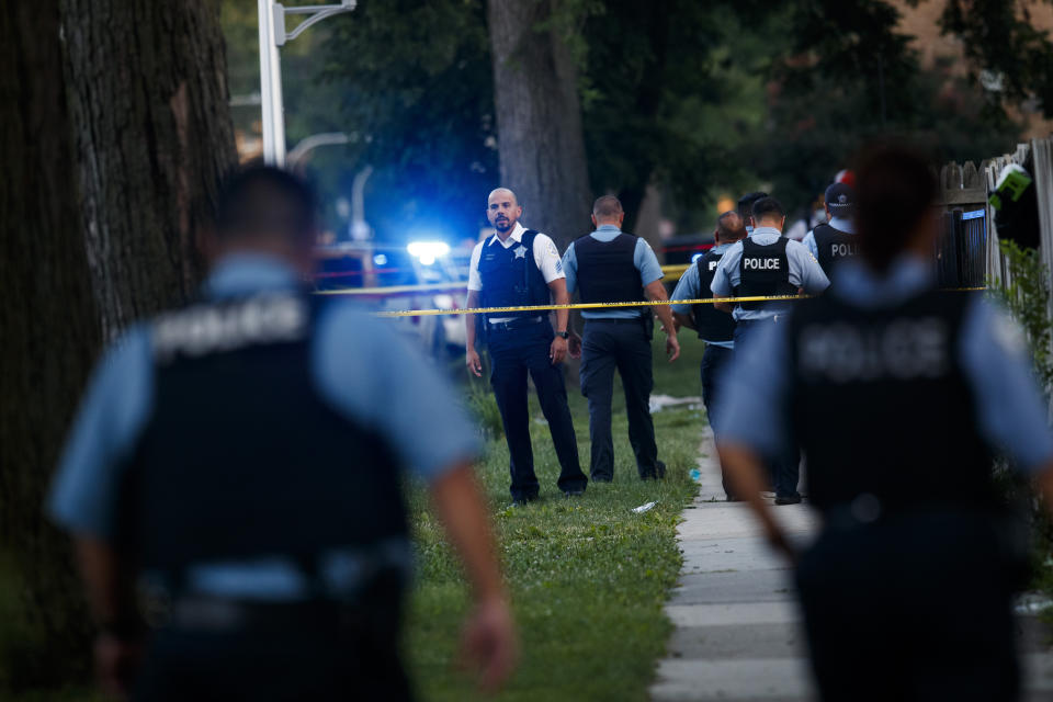 Chicago police officers investigate the scene of a deadly shooting where a 7-year-old girl and a man were fatally shot in Chicago on Sunday, July 5, 2020. At least a dozen people were killed in Chicago over the Fourth of July weekend, police said. Scores of people were shot and wounded. (Armando L. Sanchez/Chicago Tribune via AP)