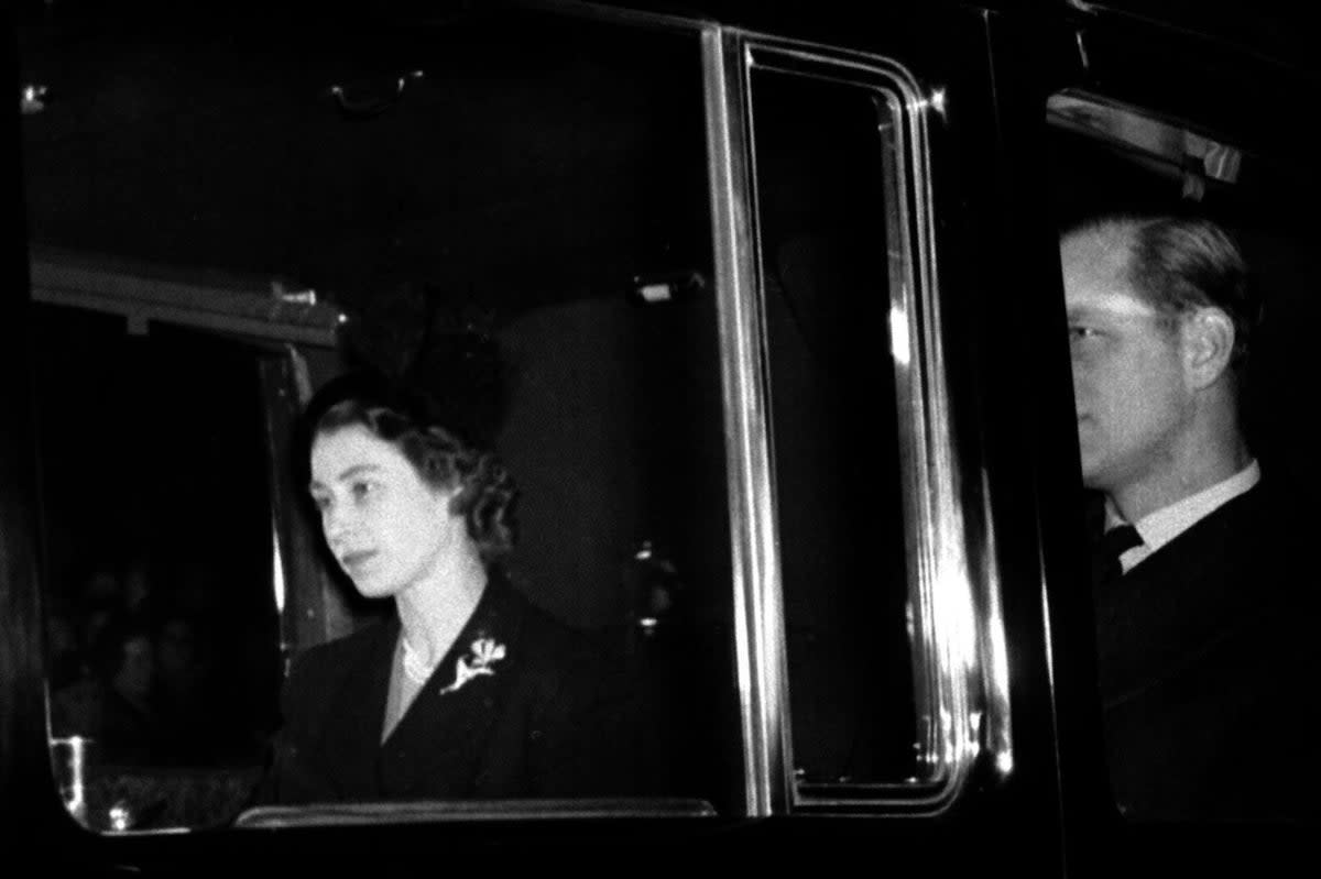 Elizabeth II returning to Clarence House with the Duke of Edinburgh from London Airport (PA)