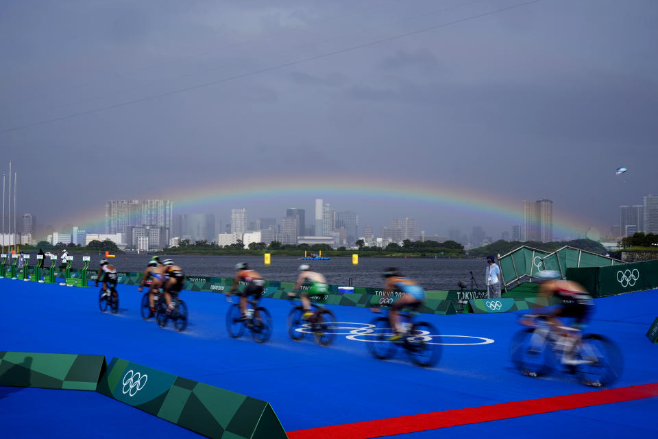 A rainbow appears as athletes compete in the bike leg of the women's individual triathlon competition at the 2020 Summer Olympics, Tuesday, July 27, 2021, in Tokyo, Japan. (AP Photo/David Goldman)