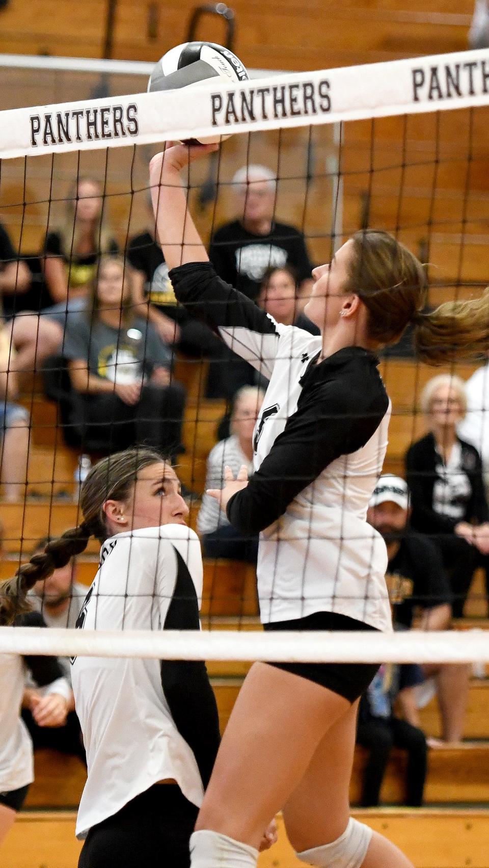 Perry's Emma Weirich tips the ball over the net during Tuesday's match against Green.