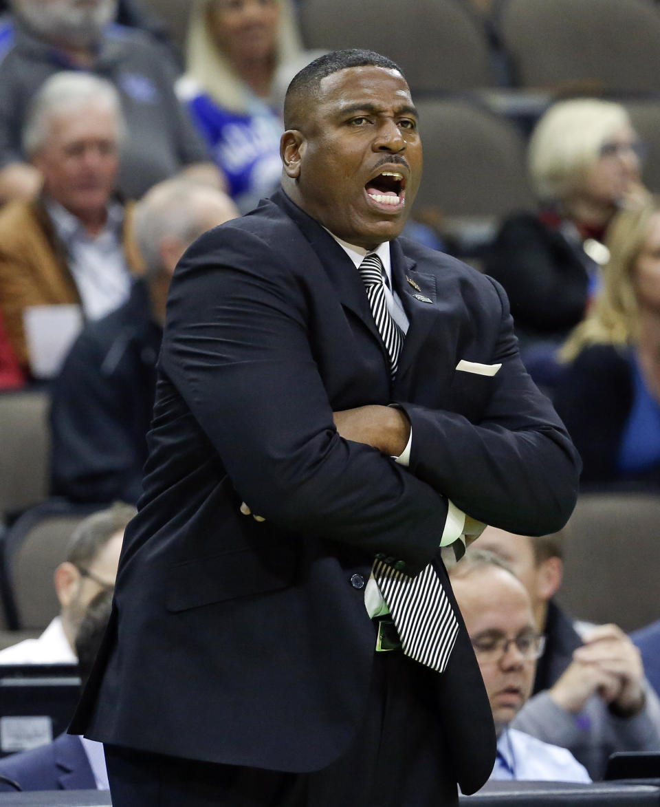 LSU's interim head coach Tony Benford shouts instructions to his players during the first half of a first round men's college basketball game against Yale in the NCAA Tournament in Jacksonville, Fla., Thursday, March 21, 2019. (AP Photo/Stephen B. Morton)