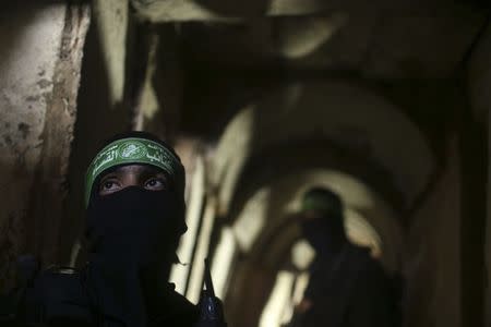 Palestinian fighters from the Izz el-Deen al-Qassam Brigades, the armed wing of the Hamas movement, stand inside an underground tunnel in Gaza August 18, 2014. REUTERS/Mohammed Salem