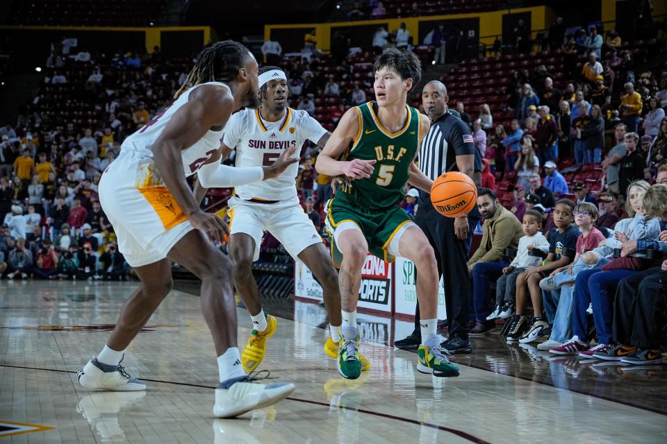 Mike Sharavjamts (5) of the University of San Francisco  started his college career at Dayton. The Dons play UC Wednesday night in an NIT first-round game.