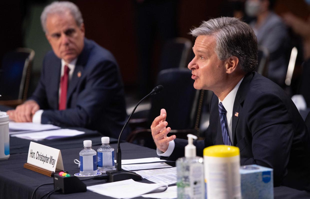 FBI Director Christopher Wray, right, and Department of Justice Inspector General Michael Horowitz testify Wednesday during a Senate Judiciary Committee hearing about the handling of the Larry Nassar investigation of sexual abuse of gymnasts.