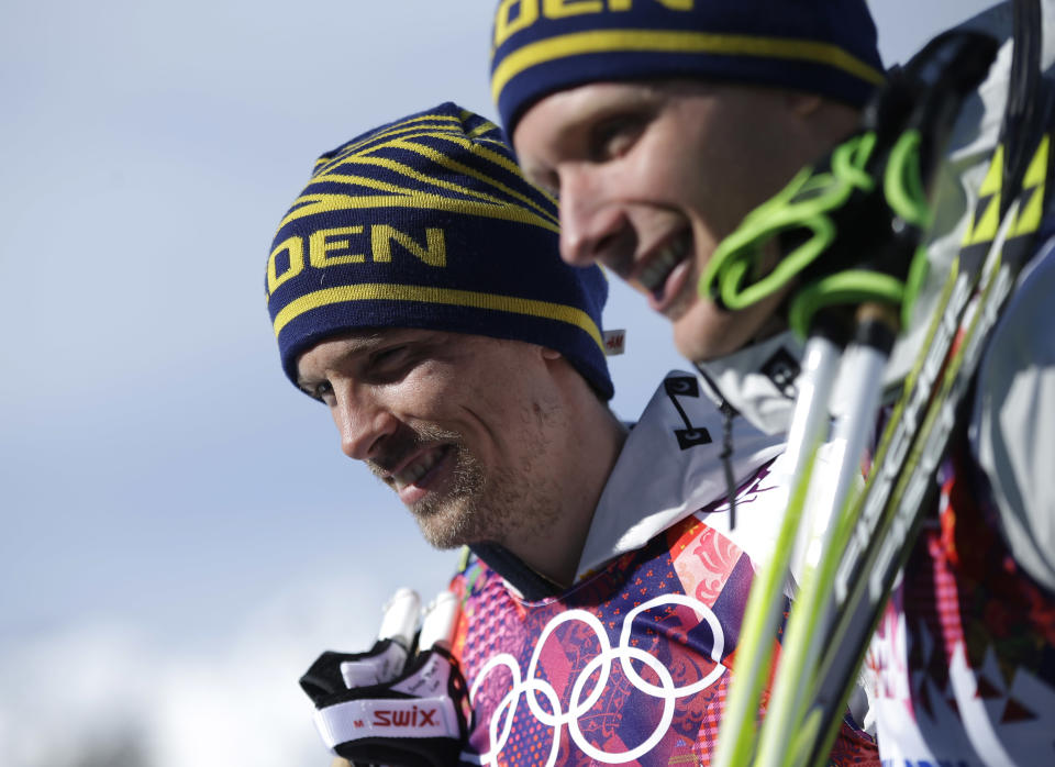 Silver medalist Sweden's Johan Olsson, left, and Sweden's Daniel Richardsson, who took the bronze, pose following the flowers ceremony for the men's 15K classical-style cross-country race at the 2014 Winter Olympics, Friday, Feb. 14, 2014, in Krasnaya Polyana, Russia. (AP Photo/Gregorio Borgia)